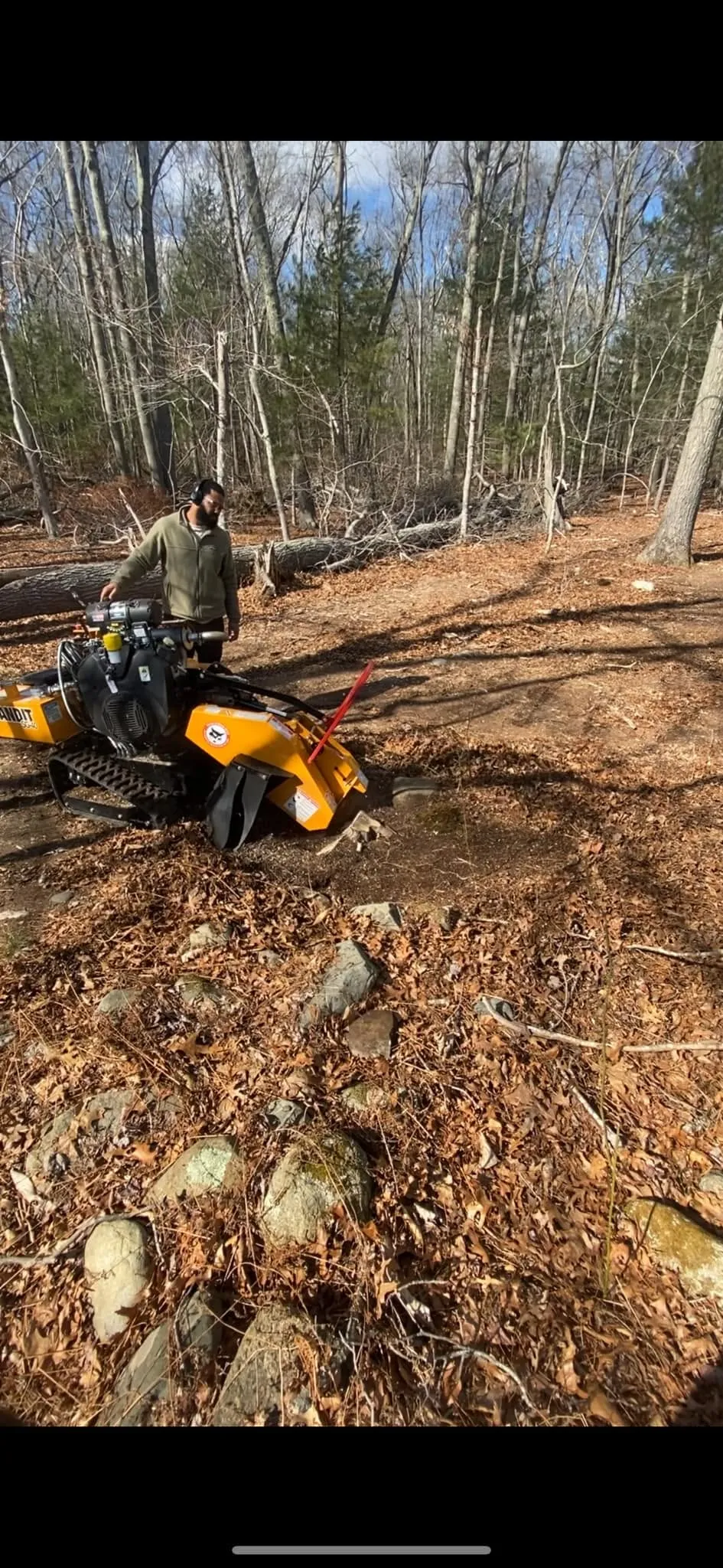 A J&D Tree Pros arborist working with equipment