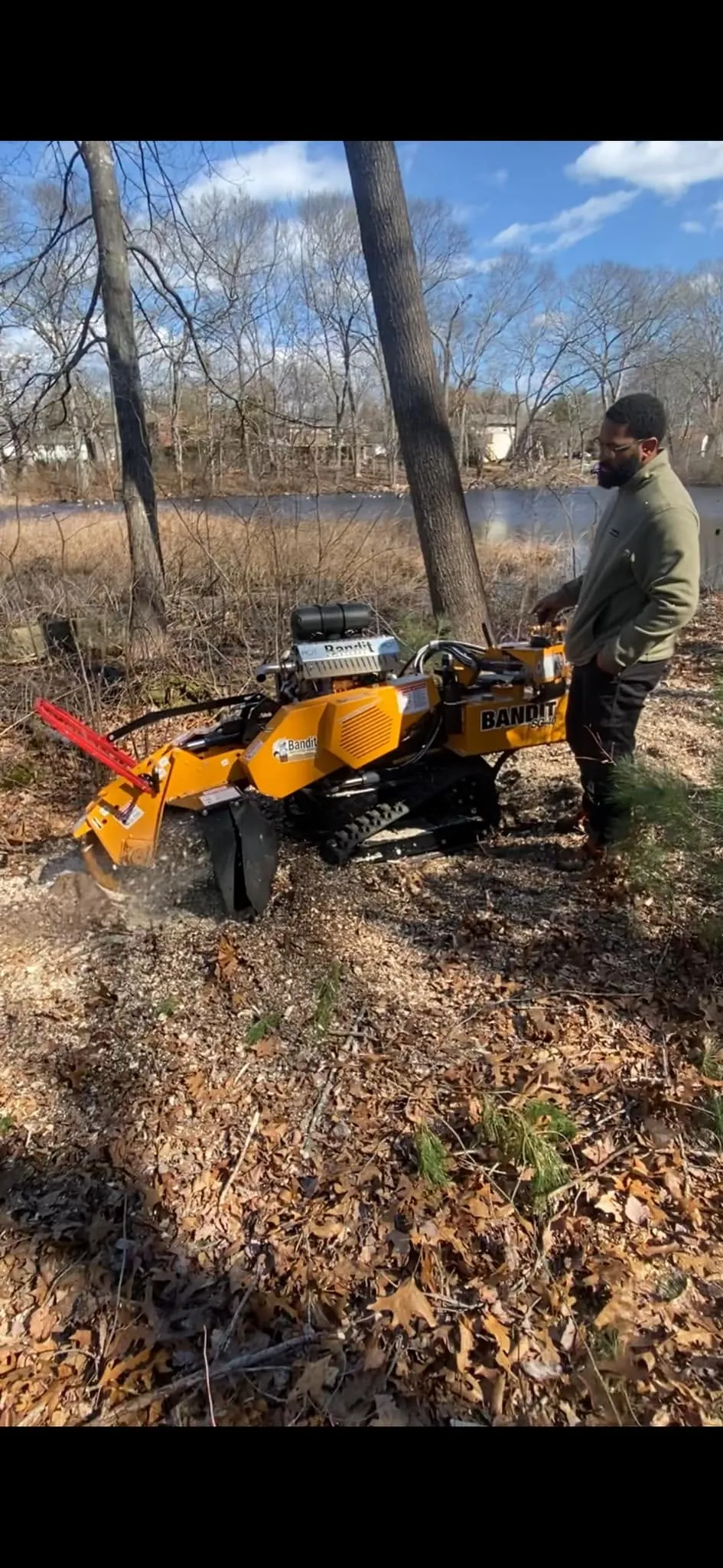 A J&D Tree Pros arborist working with equipment
